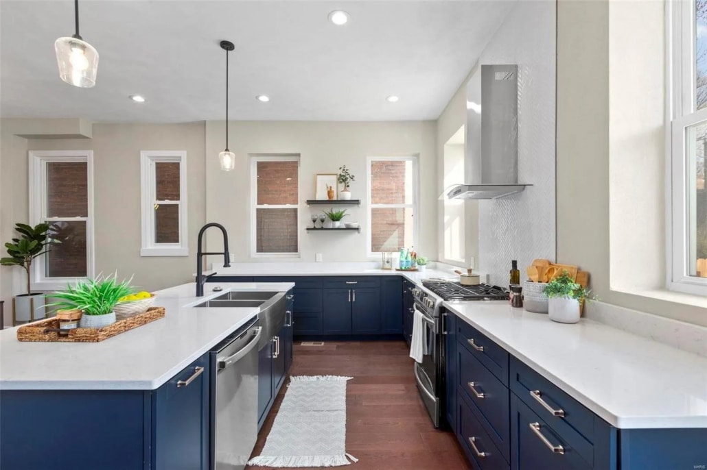Navy kitchen cabinets with white quartz countertops